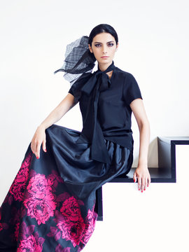 Woman In Black Shirt And Long Skirt With Floral Print Posing On Stairs