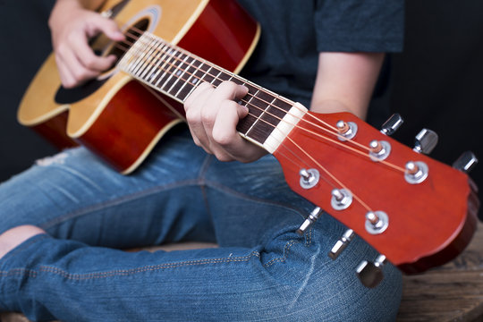 Close up of male hands playing guitar