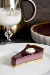 a piece of berry tart on a white plate
