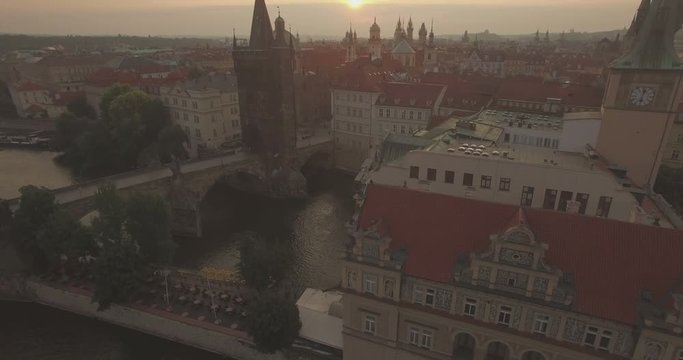 Aerial camera tracks the east tower of the Charles Bridge in Prague. Shot on a beautiful summer morning