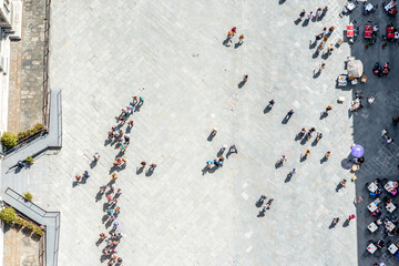 Top view on Cathedral square with people line to the bell tower of Duomo in Florence
