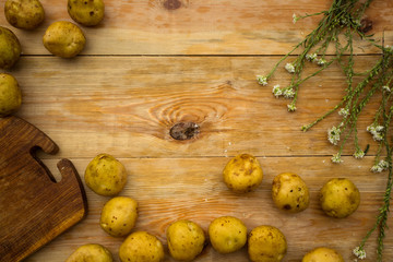 Young potato on the wooden backgrounds. Food frame.