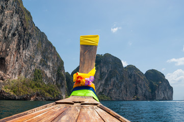 Traditional Thai Longtail boat and island of Phi Phi Leh on the