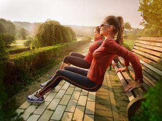 Young beautiful woman doing fitness in a park.