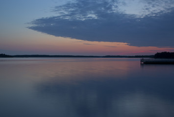 Silent night at the sea. The colorful sky with clouds.