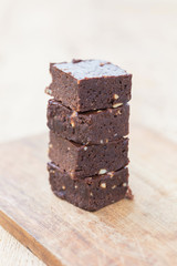 Homemade chocolate brownies over wooden background