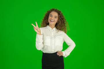The businesswoman stand and show two finger on the green background