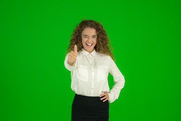 The businesswoman stand and show thumb up on the green background