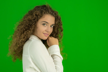 The young woman stand on the green background