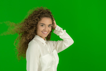 The beautiful woman stand on the green background