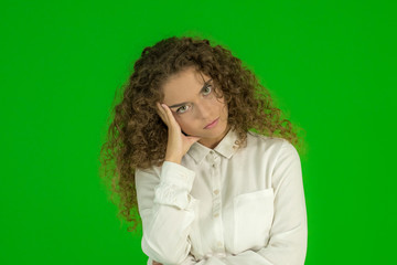 The young woman stand on the green background (stress emotion)