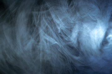 The stream of thick fume on a dark background