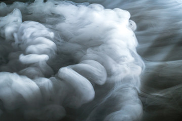 The stream of thick fume on a dark background