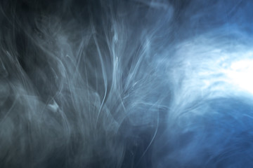 The stream of thick fume on a dark background