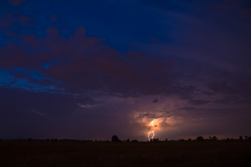 The night lightning on the background of cloud flow. Wide angle