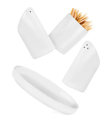 salt and pepper shakers in the air on a white background, togeth