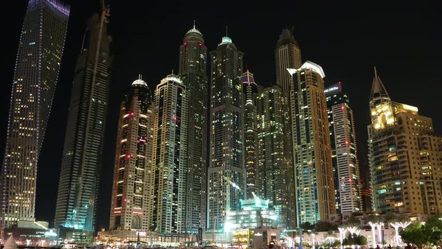UHD 4K Dubai Marina night zoom in time lapse, United Arab Emirates. Dubai Marina - the largest man-made marina in the world, is a canal city, carved along a 3 km stretch of Persian Gulf shoreline