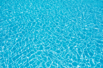 Ripple water surface with sun reflection in swimming pool