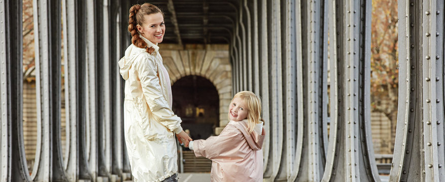 active mother and child on Pont de Bir-Hakeim bridge in Paris