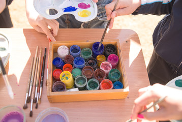 Jars of paint are on the table