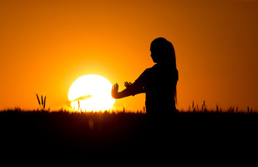 Silhouette of girl in wheat field