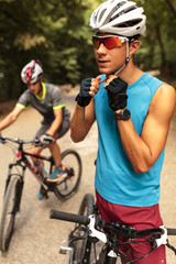 Mountain biker fixing his helmet and preparing for riding .