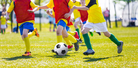 Young boys playing football soccer game