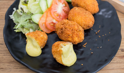 Egg fried cheese wrapped in black.