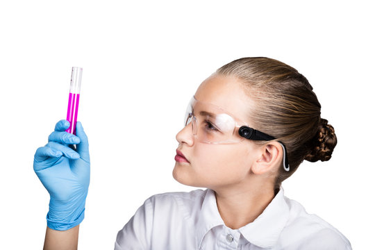 Attentive schoolgirl conducting a chemistry experiment at elementary science class