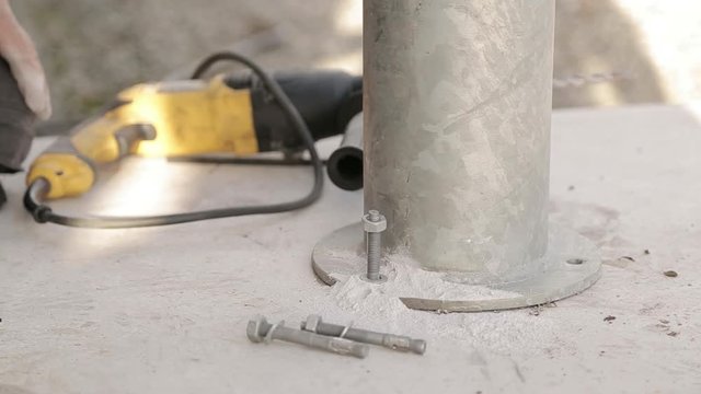 Professional places bolt in concrete