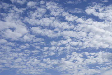 tiny clouds on blue sky