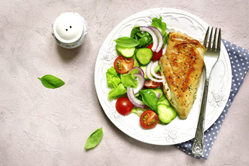 Grilled chicken fillet with vegetable salad.