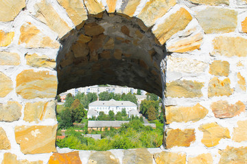 Old window in castle stone wall