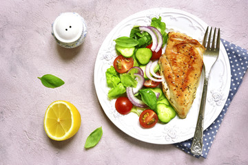 Grilled chicken fillet with vegetable salad.