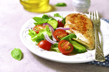 Fototapeta na wymiar Grilled chicken fillet with vegetable salad.