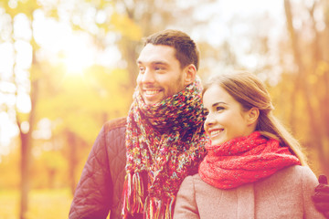 Fototapeta premium smiling couple hugging on bridge in autumn park