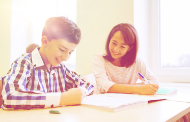 Fototapeta premium group of school kids writing test in classroom