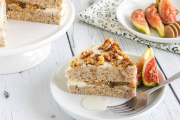 Slice of fig cake on a white plate with fresh fruit