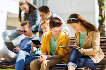 group of students with tablet pc at school yard