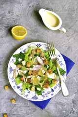 Healthy grilled chicken caesar salad with cheese and croutons.