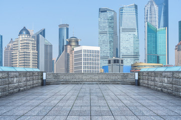 empty brick floor with city skyline background