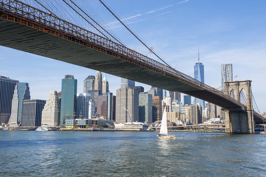 New York City skyline view of Brooklyn Bridge and Downtown Manhattan on bright summer afternoon