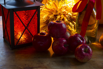 Red apples, orange lantern, a bottle of sunflower oil, ears of w