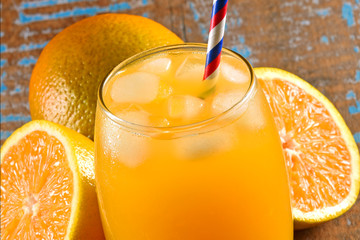 Fresh orange juice on wooden background