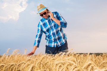 A farmer inspects a wheat field