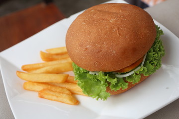 Hamburgers & French fries in a white dish.