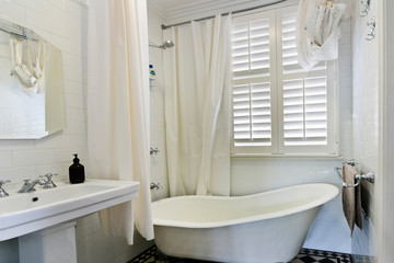 Stylish clean bathroom with shower and bath tub