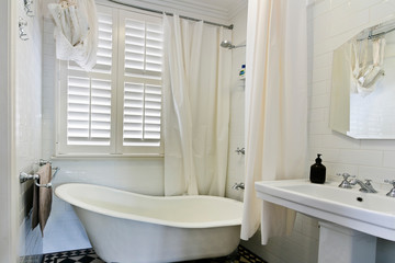 Stylish clean bathroom with shower and bath tub