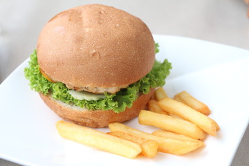 Hamburgers & French fries in a white dish.
