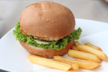 Hamburgers & French fries in a white dish.